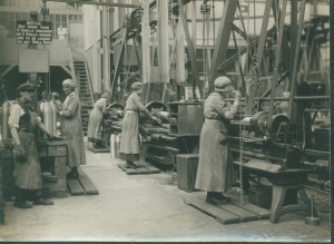 Wome workers operating milling machines.