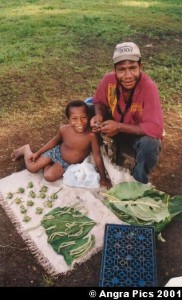 Man and child selling areca nuts and betel leaves and flowers. Photo by Austronesian Experiences. Licence: CC BY-NC-ND 2.0