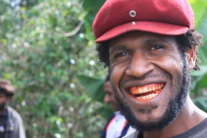 Young man with red teeth stained from betel nut chewing. Photo by counterculturecoffee. Licence: CC BY-NC-ND 2.0