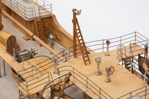 Detail of the model of ss Euterpe showing the pole compass and ladder on the bridge together with safety rails around the bridge and the normal compass binnacle and ship's wheel