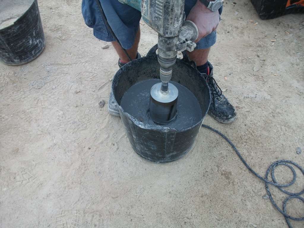 A diamond core drill being used to cut a cylinder of whinstone