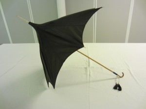 Walking parasols have  longer handles and spikes. Parasol with a pagoda shaped cover in bronze shot silk, 1862 – 1870. This may have belonged to a member of the Richardson’s, a Quaker family from Newcastle. TWCMS: K2195