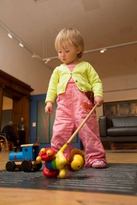 Coloured paddles are close at hand in the pocket of this Explorer's dungarees as she navigates the gallery.