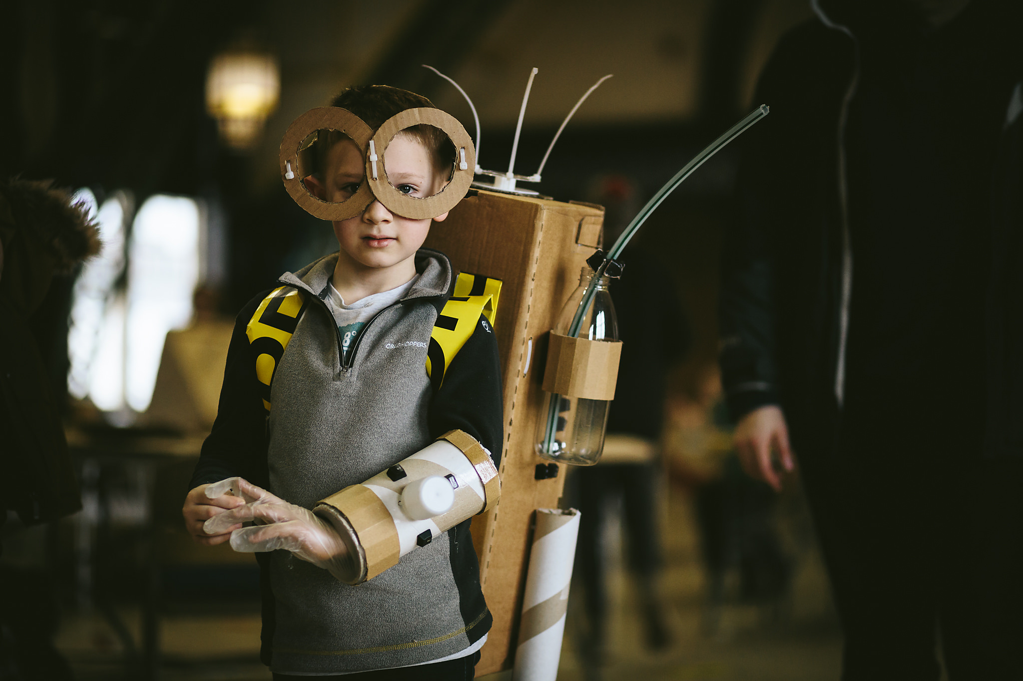 A photograph of a young child enjoying cardboard crafts at Dsicovery Museum