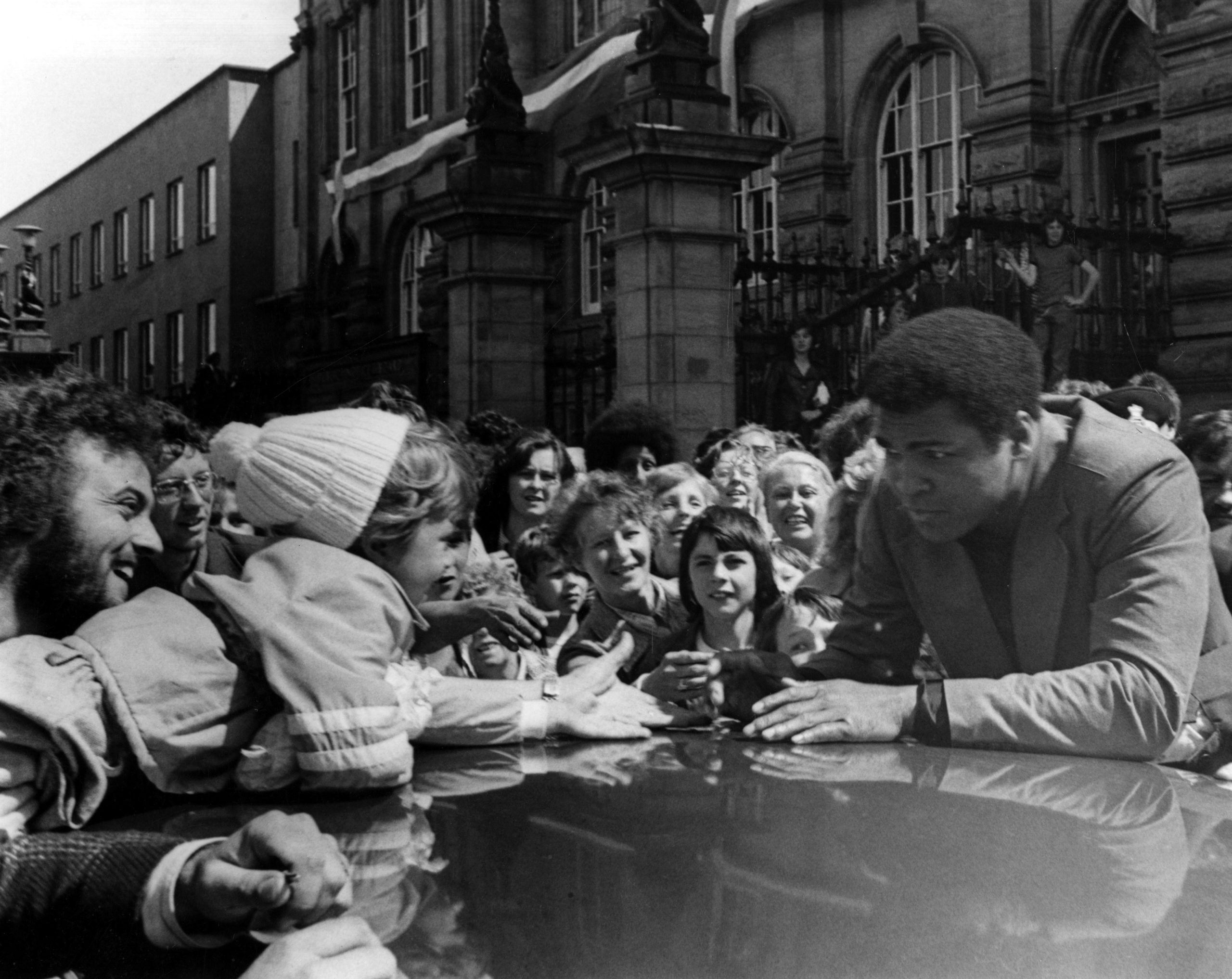 Muhammad Ali greets a young fan outside South Shields Town Hall on Saturday 16 July 1977